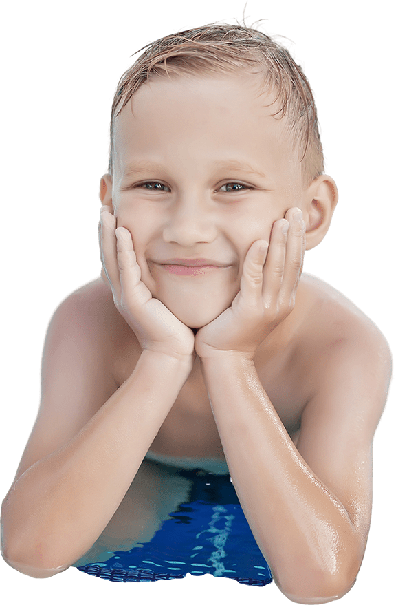 Smiling boy resting his face in his hands at the pool edge