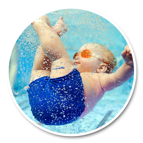 A young child in a swim cap smiling during a one-on-one pool lesson
