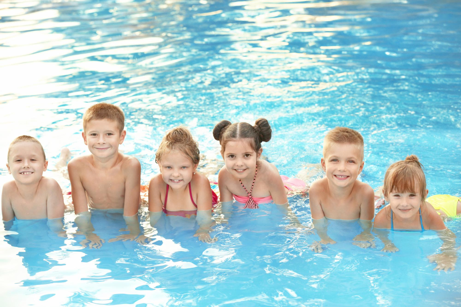 Group of children enjoying a swim class together