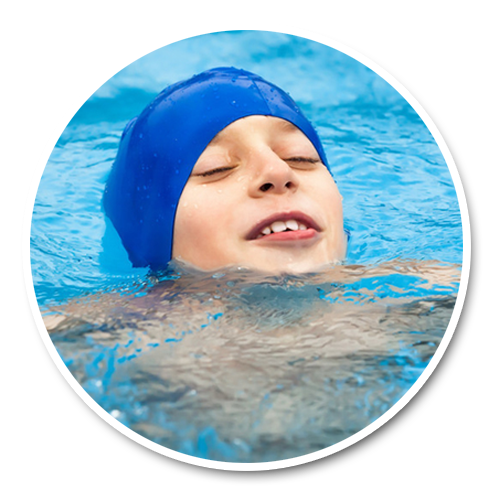 A school-age child swimming freestyle and turning to breathe